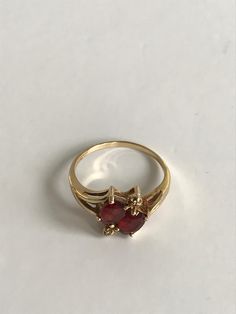 Ladies 14k Yellow Gold Vintage Two Stone Garnet Ring Ladies Size 7.5 * makes an excellent gift choice * unique ring- will not go unnoticedDisclaimer: All items in our store are vintage and pre-loved, which means they may show signs of gentle wear, including small dings, scratches, or other imperfections that add to their unique character. We do our best to describe and photograph each item accurately, but please feel free to reach out with any questions before purchasing. Thank you for appreciat 14k Gold Ruby Ring For Formal Occasions, Gold Ring With Gemstone In Heart Cut, Gold Heart Cut Gemstone Ring, Classic 14k Gold Heart Ring With Gemstone, Elegant Red Heart Ring In 14k Gold, Red Heart Ring In 14k Gold, 14k Yellow Gold Heart Ring With Gemstone, Elegant Red 14k Gold Heart Ring, Classic Open Ring For Valentine's Day