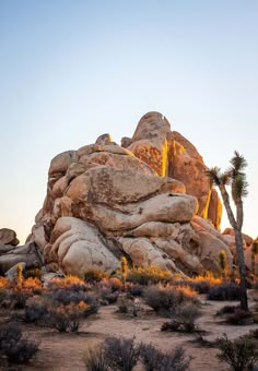 the sun is setting on some rocks in the desert