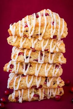 a stack of cranberry scones with white icing on top of them