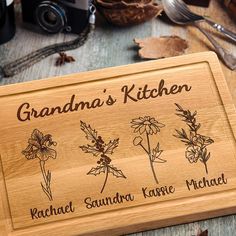 a wooden sign with flowers on it sitting next to other items and utensils