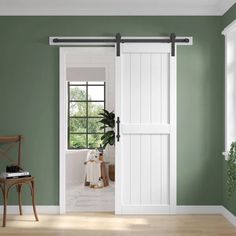 a room with green walls and white doors