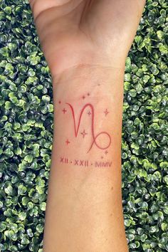 a woman's wrist tattoo with the zodiac sign virgo and stars on it