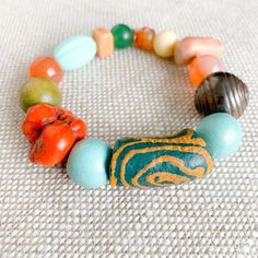 Scalia Bracelet, salty breezes, bronze skin, color bracelets. Only at BelleStyle.com. Multicolor Artisan Bracelets For Meditation, Handmade Orange Beaded Bracelets For Meditation, Earthy Wooden Beaded Bracelets For Gift, Earthy Wooden Beaded Bracelets As Gift, Multicolor Large Beaded Bracelets For Meditation, Handmade Multicolor Jade Beaded Bracelets, Spiritual Green Bracelets With Wooden Beads, Earthy Multicolor Beaded Bracelets For Meditation, Earthy Wooden Beads As A Gift