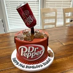 a birthday cake made to look like a can of dr pepper on top of it