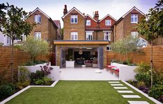 an outdoor living area with grass and plants