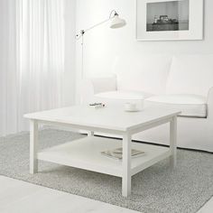 a white coffee table sitting on top of a hard wood floor