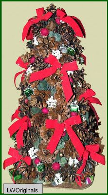 a christmas tree made out of pine cones with red bows and decorations on it's top