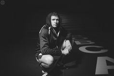 black and white photograph of a man sitting on the ground