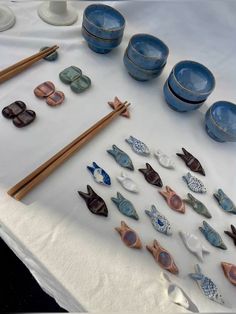 a table topped with blue dishes and chopsticks