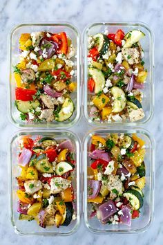 four glass containers filled with different types of food on top of a marble countertop