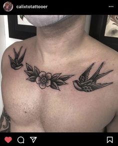 a man's chest with three birds and flowers on the chest, in black ink