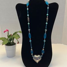 New Handmade Necklace Made With Blue Glass And Metal Beads. The Necklace Is 29.5 Inches Adjustable Blue Heart-shaped Beaded Necklaces, Blue Adjustable Heart-shaped Beaded Necklaces, Adjustable Blue Heart Beaded Necklaces, Adjustable Blue Heart-shaped Beaded Necklace, Elegant Blue Beaded Necklace With Heart Beads, Blue Heart-shaped Beaded Chain Jewelry, Blue Long Necklace For Gift, Blue Sterling Silver Single Strand Necklace, Long Blue Necklace With Polished Beads