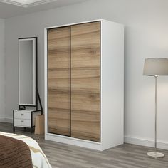 a bedroom with white walls and wooden furniture