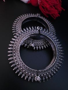 Steal everyone's attention with this stunning piece of jewellery.This kada/bracelet combines intricate detailing in a beautiful motif and contemporary design to help you make heads turn.The technique of oxidisation has been used to give a dull sheen and bring out the exquisite design.This is a bracelet that is openable and can be moulded to fit almost all sizes.Size :adjustable from 2 4 to 2.8 inches Ornate Metal Chandbali Jewelry, Festive Metal Jewelry With Intricate Design, Sterling Silver Temple Jewelry Bangle, Traditional Metal Chandbalis With Intricate Design, Oxidized Metal Chandbali Jewelry, Silver Metal Chandbalis For Wedding, Traditional Oxidized Anklets For Wedding, Traditional Sterling Silver Bracelets With Intricate Design, Traditional Wedding Anklets With Oxidized Finish