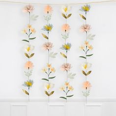 paper flowers are hanging on the wall