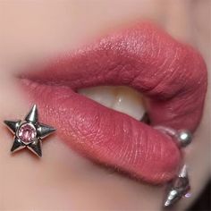 a close up of a person's lips with a star piercing