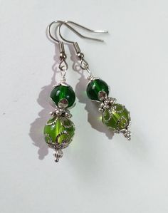 Victorian silver earrings green earrings filigree earrings Antique style silver Boho Earrings Bohemian silver green earrings gift for her Bohemian silver green filigree earrings . Antique style earrings . Silver tone beautiful Boho earrings . Bohemian earrings . Victorian style silver-tone green glass beads earrings .  Modern earrings . Chic silver toned green earrings .  Absolutely beautiful earrings ! FREE SHIPPING  Material : silver tone metal filigree beads, steel, green glass beads, Length with hooks : 2.15 ( 5.5 cm) If you have any question, please contact me ! Thank you for visiting my shop ! If you have a RUSH ORDER and you want to pay for FAST SHIPPING by DHL - 3-5 business days is HERE :  https://www.etsy.com/listing/914808240/update-fast-shipping-gift?ga_search_query=fast&ref=sh Elegant Light Green Earrings As Gift, Elegant Light Green Earrings For Gift, Handmade Lime Green Dangle Earrings, Elegant Green Sterling Silver Earrings, Nickel Free Green Metal Earrings, Green Metal Earrings For Gift, Handmade Green Sterling Silver Earrings, Green Sterling Silver Dangle Jewelry, Nickel-free Green Metal Earrings