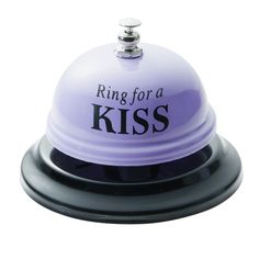 a purple and black bell with the words ring for a kiss on it's side