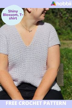 a woman sitting on top of a wooden bench