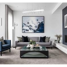 a living room with two couches and a coffee table in front of a fireplace