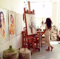 a boho home artist studio with stained wooden furniture and an easel, a metal storage shelf, baskets with lids and lots of art Room Deco, Boho Home, Studio Space, Dream Art, Room Paint