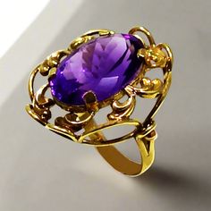 This exquisite ring is crafted from 14k gold and glistening with a deep purple amethyst. This timeless piece of jewelry will be a luxurious addition to your collection. Ring in Gold 14k Amethyst gemstone Classic Amethyst Ring Stamped 14k, Elegant Yellow Gold Amethyst Ring For Anniversary, Elegant Gold Amethyst Ring With Center Stone, Luxury 14k Stamped Amethyst Wedding Ring, Formal Purple Birthstone Ring With Prong Setting, Elegant Purple Solitaire Birthstone Ring, Elegant Purple Birthstone Ring For Formal Occasions, Elegant Formal Purple Birthstone Ring, Fine Jewelry Amethyst Ring Stamped 14k