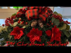 a christmas arrangement with poinsettis and pine cones