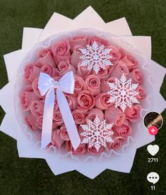 a bouquet of pink roses with white snowflakes