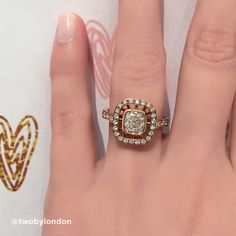 a close up of a person's hand with a diamond ring on top of it