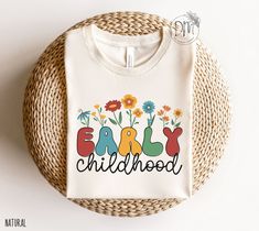 Introducing our Wildflowers Early Childhood Shirt, perfect for any member of the Early Childhood Squad! The beautiful floral design celebrates the joy of working with young children and is an ideal gift for any Daycare Teacher or Toddler Teacher. Made from high-quality materials, this shirt is both comfortable and durable, making it perfect for daily wear in the classroom. ✨ Please check the SIZE CHART image on the listing, and choose your size accordingly before placing your order.  🚫We do not Counselor Appreciation Gifts, Nana T Shirts, Gigi Shirts, Counselor Gifts, Women Scientists, Nana Shirts, Science Shirts, Emergency Nursing, Tech Shirt