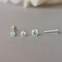 This is a set of a CZ ear piercing jewelry removable end, which has a AAA Cubic Zirconia prong setting, with a threadless push back post.RECOMMENDED WEARING POSITIONEAR PIERCING- Helix, Earhead/Forward Helix- Tragus, Anti-Tragus/Surface Tragus- Cartilage/Flat - Conch, Inner Conch, Outer Conch- Lobe/Standard Lobe, Upper LobeMATERIAL- AAA Cubic Zirconia- 925 sterling silver- 925 sterling silver threadless push back postMEASUREMENT* Removable End Size:-- CZ size : 2.5 mm, 3 mm, 4 mm* Flat Back Post Everyday Silver Cubic Zirconia Piercings, Minimalist Internally Threaded Cubic Zirconia Piercings, Minimalist Cubic Zirconia Piercings For Gift, Silver Minimalist Cubic Zirconia Piercings, Silver Minimalist Piercings With Cubic Zirconia, Single Earring Cubic Zirconia Piercing As Gift, Minimalist Nose Ring With Prong Setting, Minimalist Silver Internally Threaded Piercings, Silver Minimalist Cubic Zirconia Cartilage Earrings