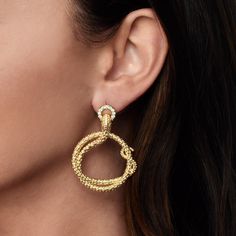 Elevate your style with the luxurious Serpent Holding Ring Hoop Earrings. Crafted from 18K gold dipped brass and adorned with sparkling handset pavé crystals, these earrings exude sophistication and opulence. 18K gold plated brass Crystals 2" L X 1.4" W Luxury Party Hoop Earrings With Plating, Glamorous Gold Jewelry With Pave Setting, Gold Metal Hoop Earrings With Sparkling Stones, Luxury Gold Hoop Earrings With Pave Setting, Gold Diamond Hoop Earrings For Evening, Glamorous Yellow Gold Hoop Earrings, Gold Diamond Hoop Earrings For Party, Elegant Yellow Gold Hoop Earrings With Sparkling Stones, Glamorous Gold Diamond Hoop Earrings