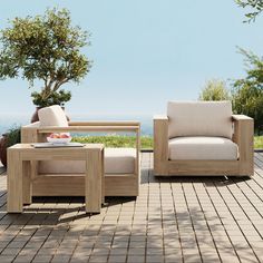 two wooden chairs sitting on top of a patio