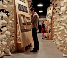 a man standing in front of a wooden display