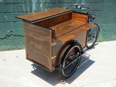 an old fashioned bike with a wooden box on the back