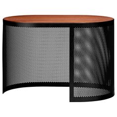 an oval wooden table with black mesh covering