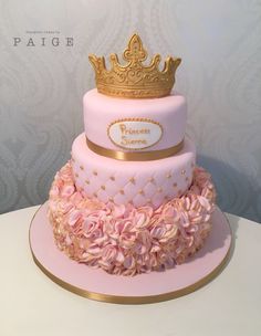 a pink and gold cake with a crown on top