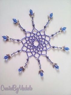 a crocheted snowflake with blue beads