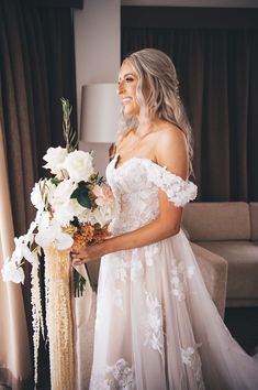 a woman in a wedding dress holding a bouquet