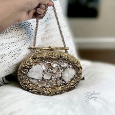 Introducing our mother of Pearl Clutch- a true masterpiece of elegance. This oval shaped clutch features a luxurious 14k gold frame, complemented by meticulous peals and Crystal embellishments. The inner lining, crafted with plush suede fabric, enhances the tactile experience, making it as delightful to touch as it is to behold. The meticulous attention to detail extends to the heavy premium quality chain, ensuring a seamless blend of style and practicality. With dimensions of 7X5 inches, this c Luxury Evening Bag With Gold-tone Hardware For Gift, Luxury Gold Clutch With Gold-tone Hardware, Elegant Evening Jewelry With Gold Clasp, Elegant Jewelry With Gold-tone Hardware For Formal Occasions, Elegant Formal Jewelry With Gold-tone Hardware, Handmade Glamorous Evening Bag For Wedding, Elegant Clutch With Gold-tone Hardware, Rectangular Evening Bag With Gold-tone Hardware For Wedding, Gold-tone Clutch Evening Bag As Gift