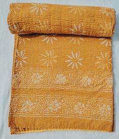 an old yellow cloth with white flowers on it