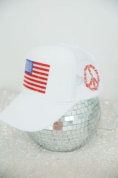 This RHINESTONE FLAG WHITE TRUCKER HAT is a must-have for any fashionista. It features a stylish rhinestone flag and peace sign, ensuring you stand out from the crowd. The mesh back provides a cool, comfortable fit. Make a statement with this designer-inspired trucker hat. All orders are currently shipping within 14 business days. To receive item quicker, expedited shipping is available at checkout. Cheap White Trucker Hat For Sports Fans, White Trucker Hat, Peace Sign, Stand Out From The Crowd, Trucker Hat, Comfort Fit, Flag, Design Inspiration, Mesh