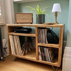 an old record player sits on top of a wooden shelf