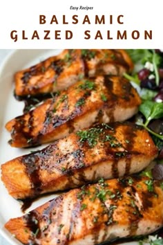 grilled salmon with balsamic glaze is on a white plate and garnished with fresh greens