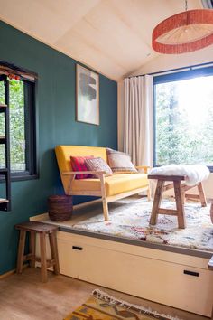 a living room filled with furniture next to a window