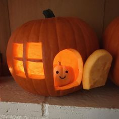 a pumpkin carved to look like a house