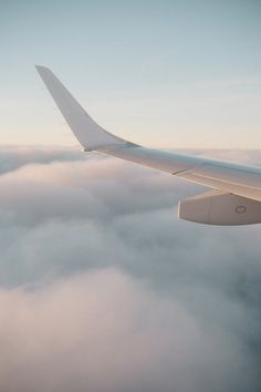 the wing of an airplane flying above the clouds