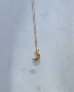 24k gold-plated crescent moon charm with zircon gems on a 14k gold-plated or 14k gold-filled chain. Necklaces are 16 inches in length with a 2 inch extender chain. Dainty Crescent Yellow Gold Necklace, Dainty Yellow Gold Crescent Necklace, Dainty Crescent Yellow Gold Charm Necklaces, Everyday Gold Crescent Charm Necklace, Dainty Yellow Gold Crescent Charm Necklaces, 14k Gold Crescent Celestial Necklace, Delicate Crescent Moon Charm Necklace, Dainty Yellow Gold Moon Charm Necklace, Everyday Crescent Necklace With Delicate Chain