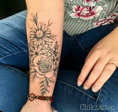 a woman with a flower tattoo on her arm