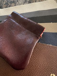 "This leather pouch is a great way to store earbuds, coins, jewelry, and other small items. It is made from 100% leather and secured with a \"snap\" Flex Frame. This pouch measures 3.75\" at its bottom widest point. It is 3.5\" high and the opening of the pouch has a 3.25\" flex frame snap closure." Brown Leather Travel Coin Purse, Soft Leather Pouch For Personal Use, Brown Leather Zipper Pouch, Brown Pouch With Card Slots For Personal Use, Red Leather Pouch Coin Purse, Classic Leather Pouch Coin Purse, Classic Leather Coin Purse Shaped As Pouch, Brown Leather Pouch With Smooth Grain, Classic Leather Coin Purse